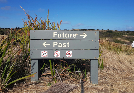 A signpost pointing to "Past" and "Future"